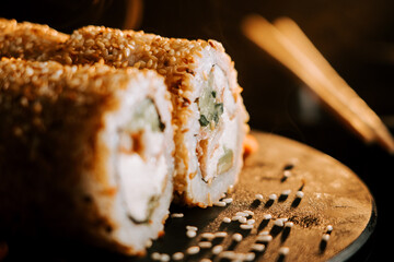 Fresh sushi with sesame and ginger on a black background. Sushi concept
