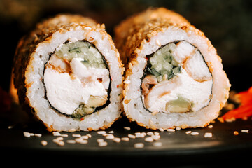 Fresh sushi with sesame and ginger on a black background. Sushi concept
