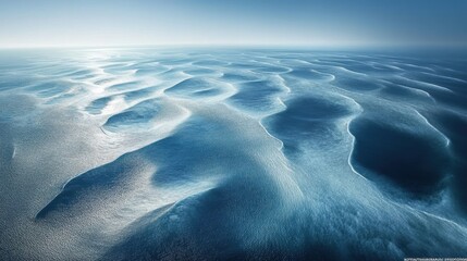 Gentle ocean waves form intricate patterns on the water's surface, reflecting soft morning light in a serene coastal environment. Generative AI