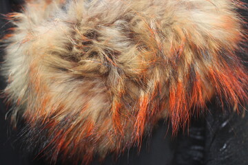 Closeup of brown faux fur collar with red tinge