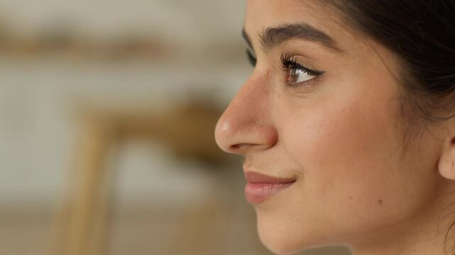 Female profile face head portrait from side Indian woman Arabian girl lady indoors at home looking at front smiling happy smile positive dreaming cosmetology healthy skin dermatology cosmetic health