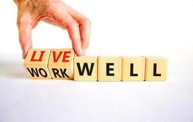 Live or work well symbol. Concept words Live well Work well on wooden cubes. Beautiful white table white background. Businessman hand. Business and live or work well concept. Copy space.