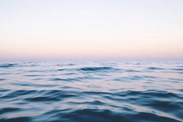 Fototapeta premium 静かな海の水平線と柔らかな夕暮れの色合いが広がる風景