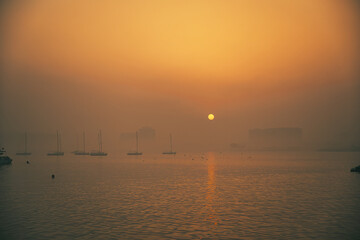 Fototapeta premium Doha, Qatar, December 27, 2024: Sailboats in fog.