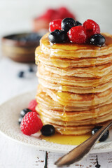 Pancakes with berries in rustic style