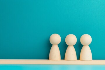 Team Collaboration Unity Concept - Three wooden figures symbolize teamwork, unity, collaboration, partnership, and support.  Simple, clean image.