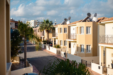 Sunny Residential Street with Modern Houses and Palm Trees