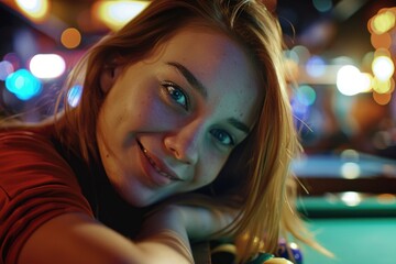 Fototapeta premium Pretty young woman enjoying drinks, pool table in background.
