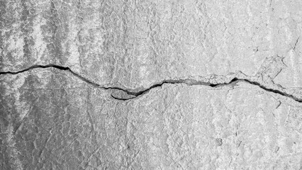 Old cracked concrete wall. Black and white background. Cracked concrete wall. Crack wall texture. 