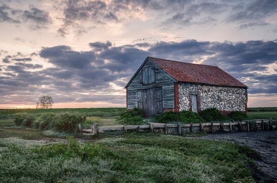 Dramatic cloudy sunset at Thorham Barn