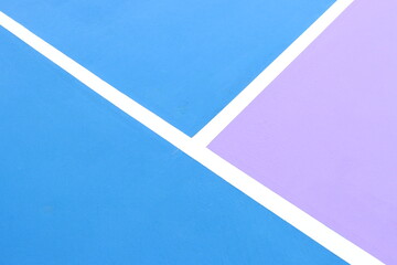 Pickleball court to view of the lines and the colorful contrast with the kitchen area in purple and blue 