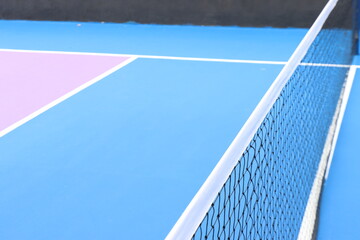 Pickleball court to view of the lines and the colorful contrast with the kitchen area in purple and blue 