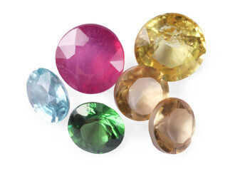 Different colorful shiny gemstones isolated on white