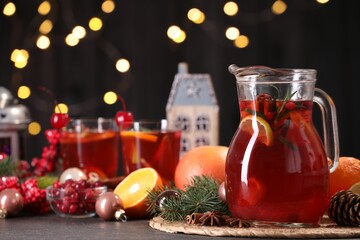 Tasty punch drink and Christmas decor on grey table