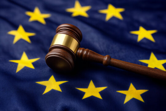 The image features a gavel resting atop a European Union flag