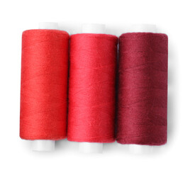 Spools of colorful sewing threads isolated on white, top view