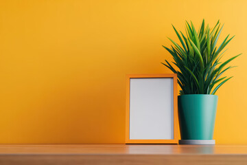 vibrant yellow wall complements potted plant and blank frame, creating cheerful and minimalistic decor