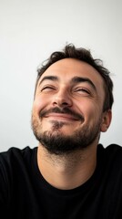 Fototapeta premium A man smiles, looking upward. AI.