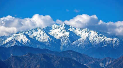 Obraz premium A stunning view of snow-capped mountains under a clear blue sky, showcasing the beauty of nature and the grandeur of the landscape.