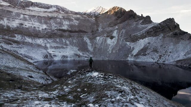 Incredible aerial views of the snow-covered Ib&oacute;n de Sabocos in Panticosa, Aragon: a young man contemplates the magical landscapes of the Tena Valley in the Pyrenees from the Tende&ntilde;era Mountain Range