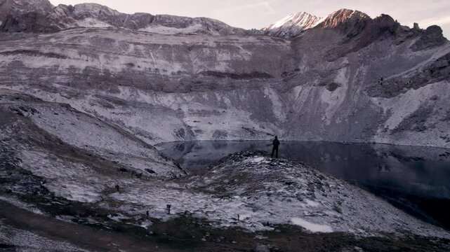 Aerial views of the snow-captured Ib&oacute;n de Sabocos in Panticosa, Tena Valley, Pyrenees, Aragon: a young man admiring the winter beauty captured by drone over the Sierra de Tende&ntilde;era in a dreamlike