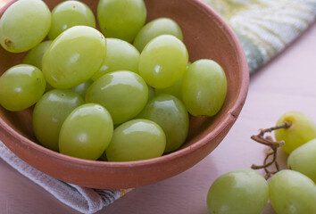 Ripe green grape in small ceramic bowl