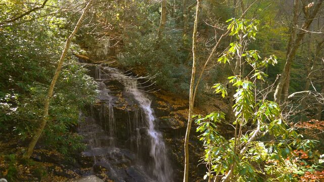Beautiful waterfall ,Soco Falls is a beautiful, double waterfall on the edge of the Cherokee Indian Reservation in North Carolina, seen here in autumn bordered by colorful autumn leaves.