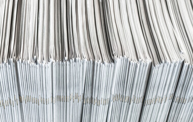 Newspaper, magazine or comic pile stacked horizontally on mainstream media newsstand. The...
