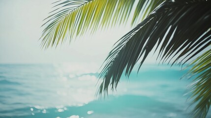 Fototapeta premium Palm tree branch swaying over a turquoise ocean, tropical beach setting generative ai