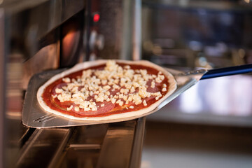 The chef prepares pizza. Raw pizza ready to oven