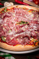 Pizza carpaccio with arugula parmesan cheese. Carpaccio on pizza