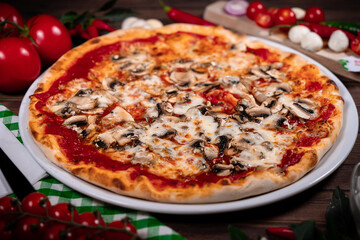 Pizza funghi with tomato sauce, mozzarella and fresh mushrooms