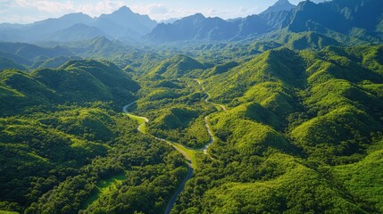 Lush green mountains and winding river in a serene landscape during daytime in a tropical region