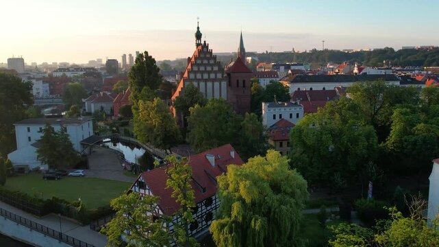 Drone flight from Mill Island towards the cathedral and market square in Bydgoszcz. Late spring morning.
