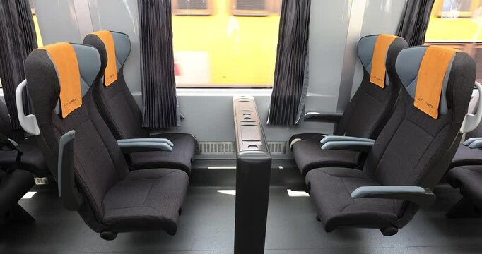 4k movie with second class car interior in the train, with row front view of modern wagon for passanger photographed in natural light.