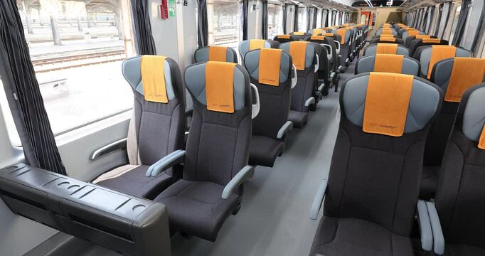 4k movie with second class car interior in the train, with row front view of modern wagon for passanger photographed in natural light.