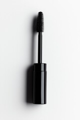 Obraz premium Black tube of mascara with long wavy brush on white background