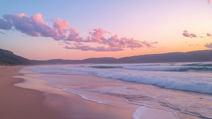 A serene beach at sunset, featuring soft waves, gentle sand, and pastel clouds illuminating the horizon.