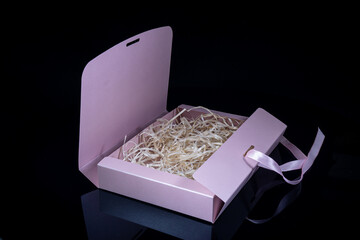 Man gift concept. Open gift box with luxury bow on dark background. Horizontal with copy space.