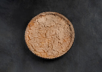 Shortbread tart with berries and fruits on a dark background close-up