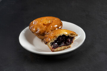 Shortbread tart with berries and fruits on a dark background close-up