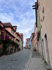 One of the narrow streets with colorful old houses of Rothenburg ob der Tauber, Bavaria, Germany