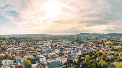 Golden Hour Cityscape: A panoramic aerial view captures the warmth of a setting sun illuminating a charming European city, with lush greenery and vibrant buildings stretching out towards the horizon.