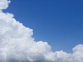 Puffy cumulus clouds in blue sky