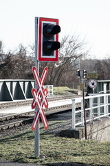 Rail tracks with traffic light and traffic sign