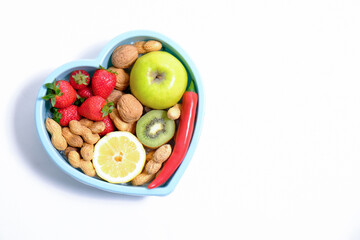 Heart shaped dish with vegetables isolated on white background