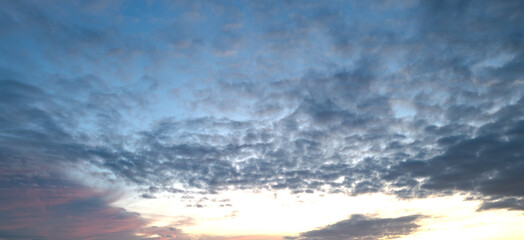 Sunrise background. Dramatic sunset background. Sky with clouds in Sunrise sky light background. Sunrise with clouds in various shapes background. Calm Sunrise.