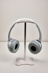Wireless headphones hanging on stand