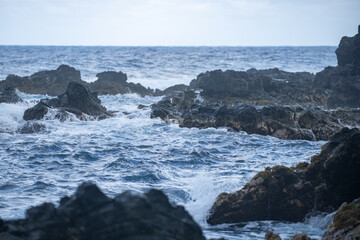 Wave hit the rock at beach, sea water splash at sea. Seascape. Splashes from the waves bumping against the rocky shore.