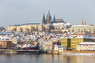 Snowy Prague Lesser Town with Prague Castle above River Vltava, Czech republic 